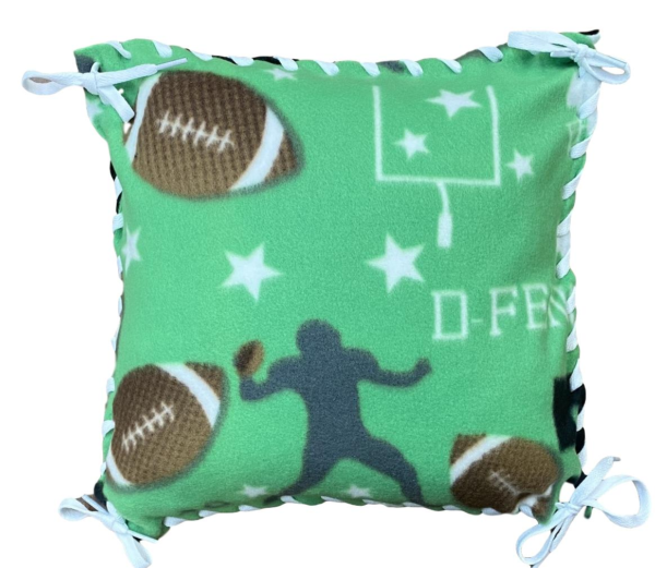 Fleece pillow kit football pattern with green field, white goal post, brown footballs and gray player silouhette