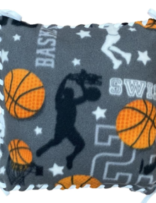 fleece pillow kit basketball pattern on gray background with orange basketballs, white lettering, and black silouhettes of players