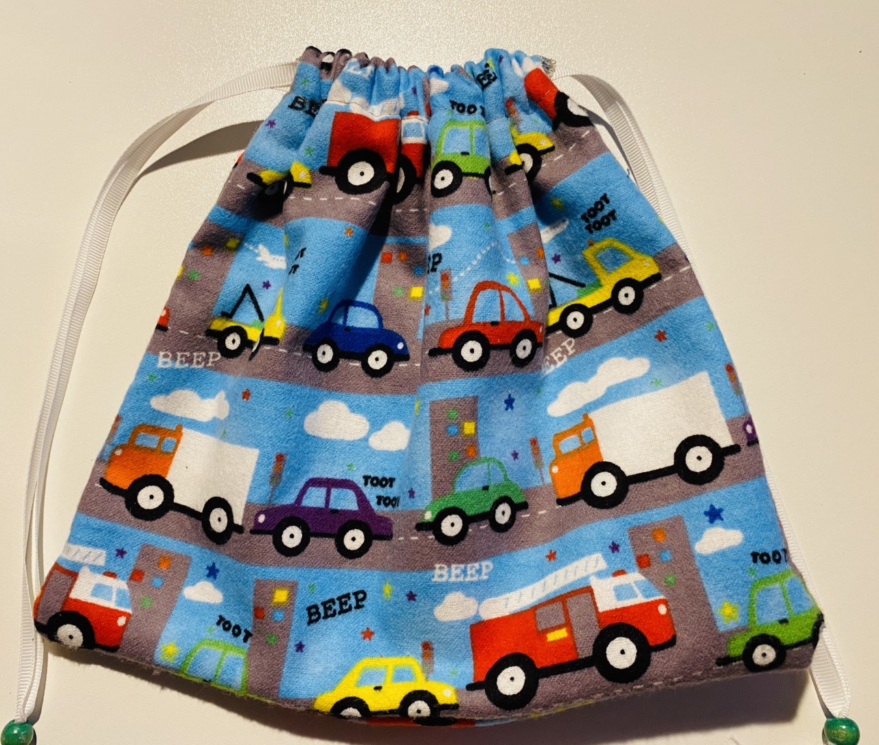 10 inch flannel drawstring gift bag with cars, trucks, fire trucks, beep beep images