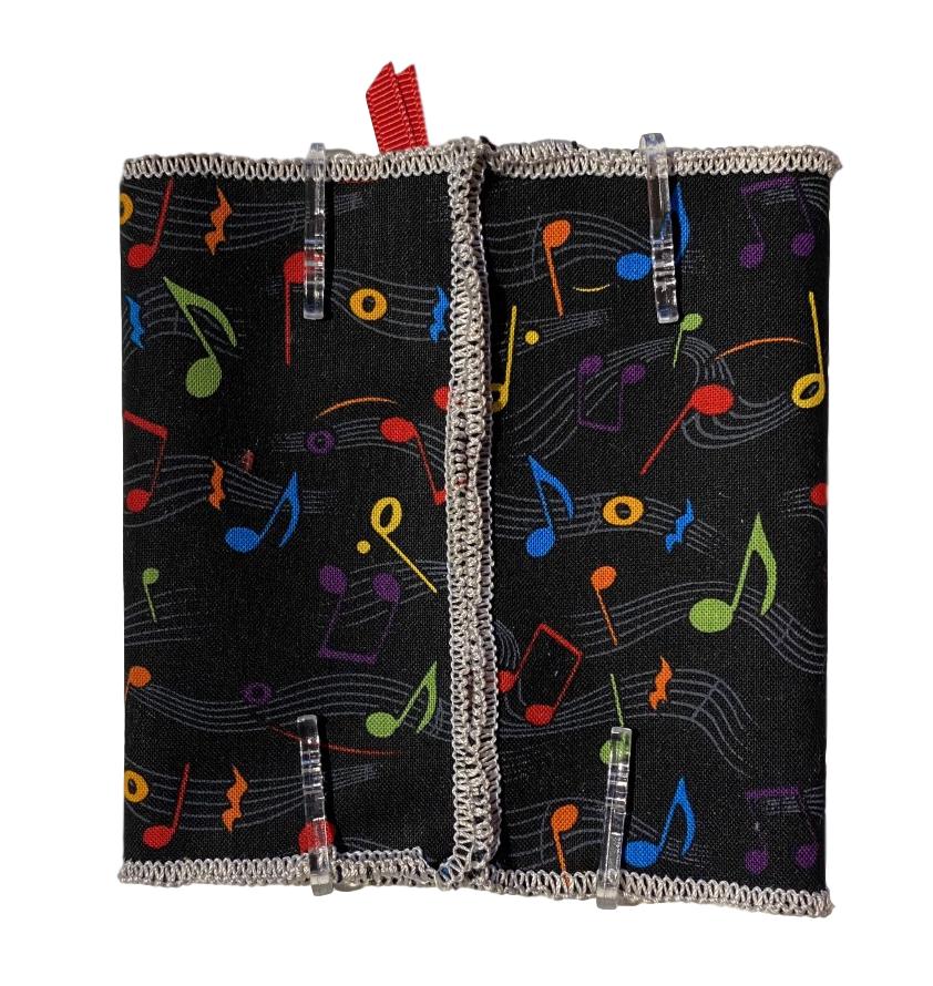 music notes tissue holder kit with black background, gray stanzas, and red, blue, green, orange and yellow music notes