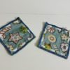 Set of 2 No sew 4.5 inch coasters with light blue background and white, red, green iced Christmas Cookie pattern