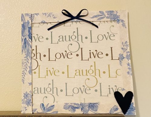 Live Laugh Love Wall Hanging Kit with Home Decor fabric with Live Laugh Love writing in Teal blue, tan and sage and vintage style frame in off white with blue floral