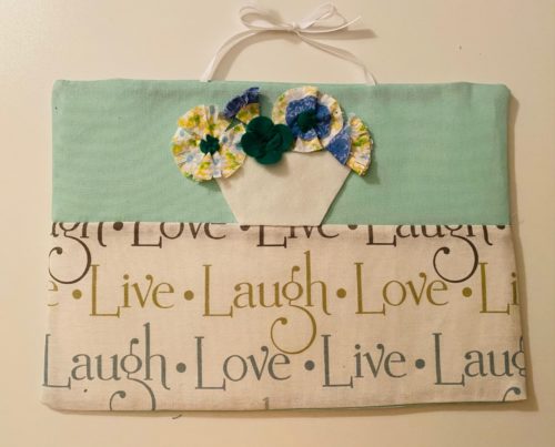3d flowers in vase on wall hanging with live laugh love and seafoam fabric