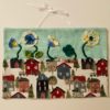 3d fabric flowers on wall hanging with neighborhood house fabric and seafoam green