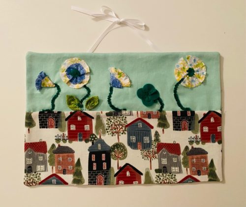3d fabric flowers on wall hanging with neighborhood house fabric and seafoam green