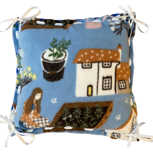 Light blue fleece pillow with houses and girls working in gardens