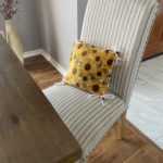 Sunflower fleece pillow set on a dining room chair