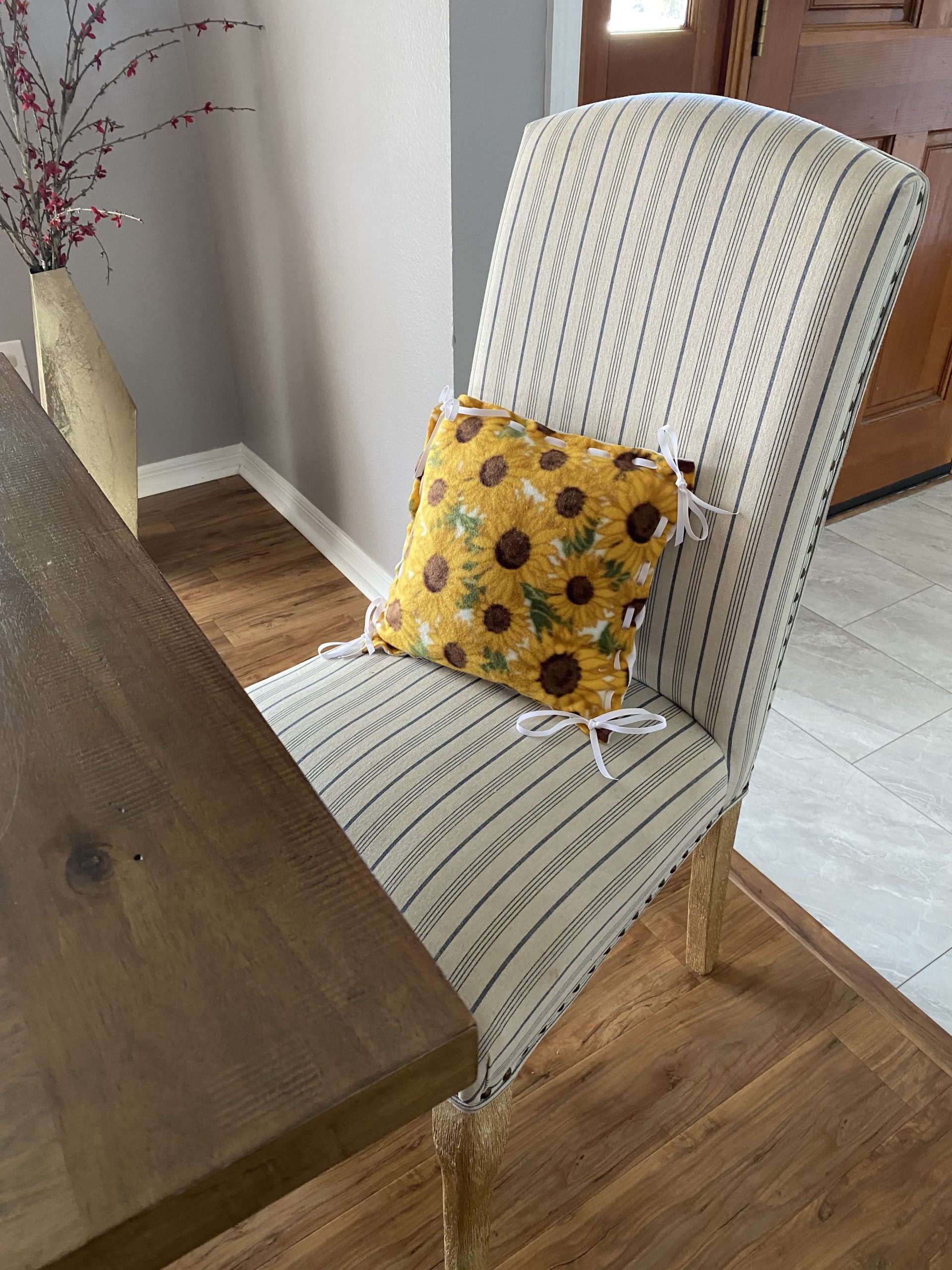 Sunflower fleece pillow set on a dining room chair