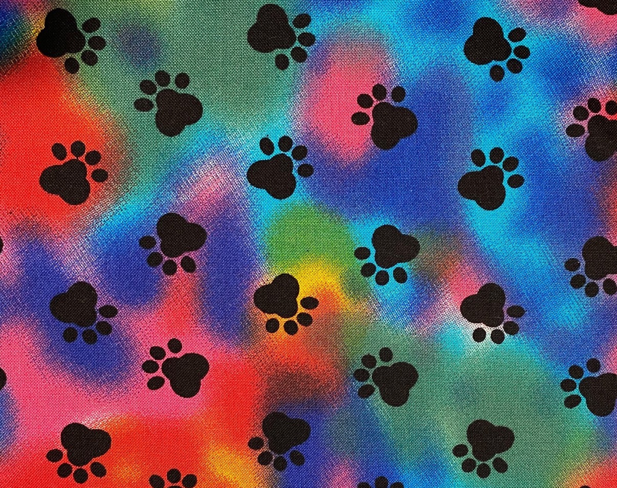 Red blue green and yellow tiedie with black paw prints