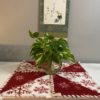 25 inch fleece pinwheel red and white snowflake table topper on desk with plant
